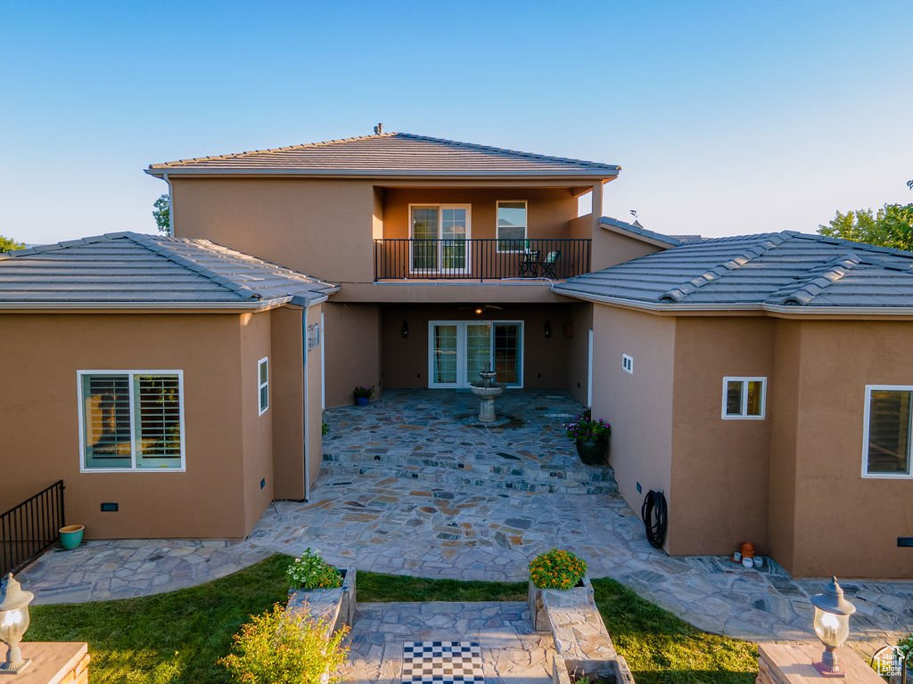 Back of house featuring a balcony and a patio area