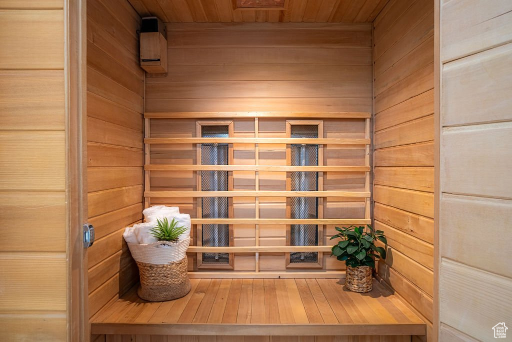 View of sauna / steam room featuring wooden walls and wood ceiling