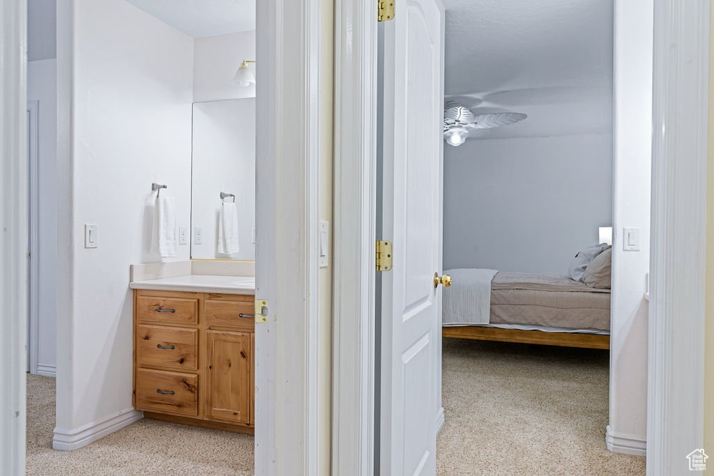 Interior space featuring ceiling fan and vanity