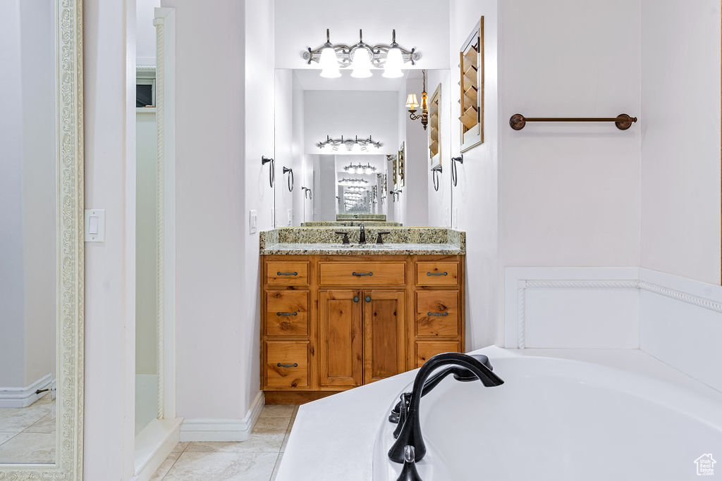 Bathroom with a tub to relax in and vanity