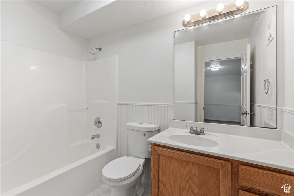 Full bathroom with vanity, toilet, and washtub / shower combination