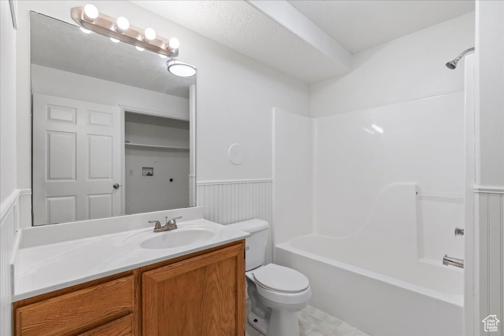 Full bathroom featuring  shower combination, vanity, and toilet