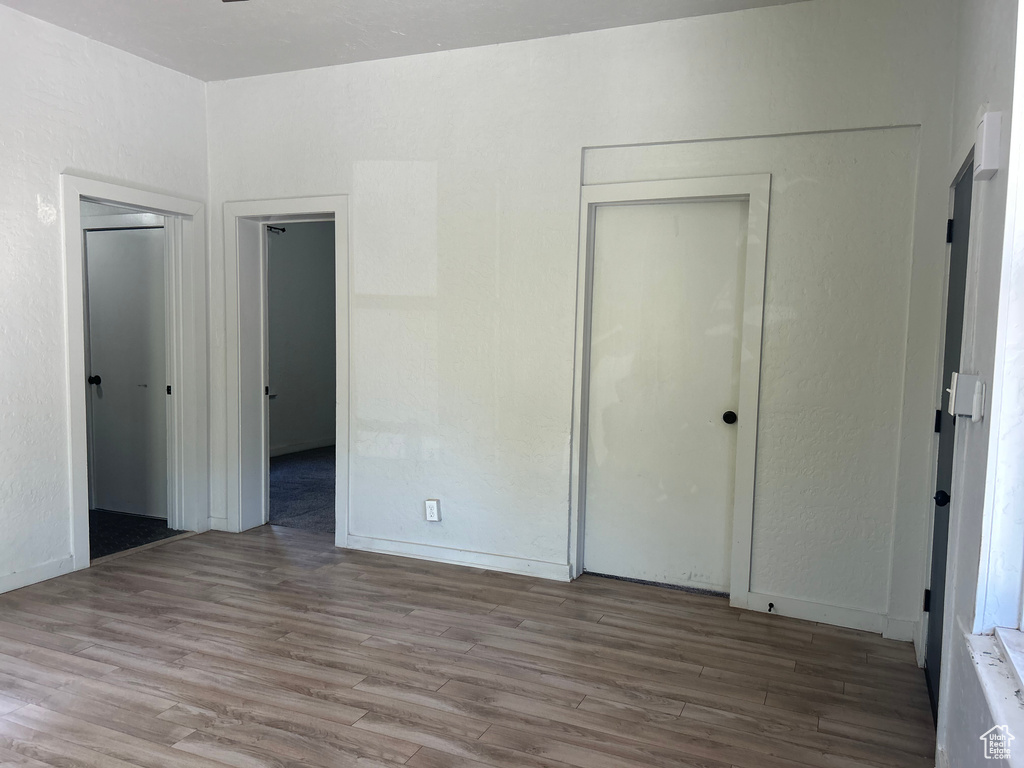 Unfurnished bedroom featuring hardwood / wood-style floors