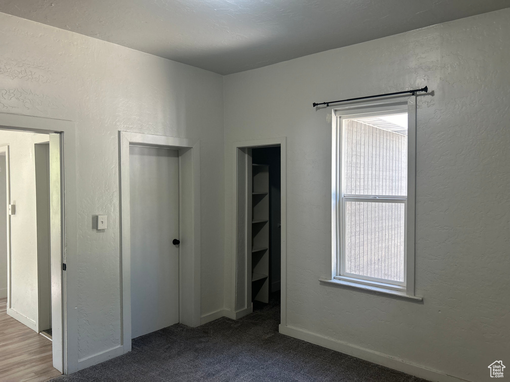 Unfurnished bedroom with light carpet