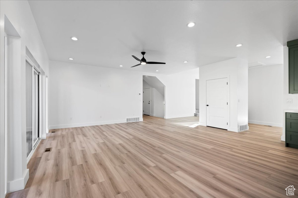 Unfurnished living room featuring light hardwood / wood-style floors and ceiling fan