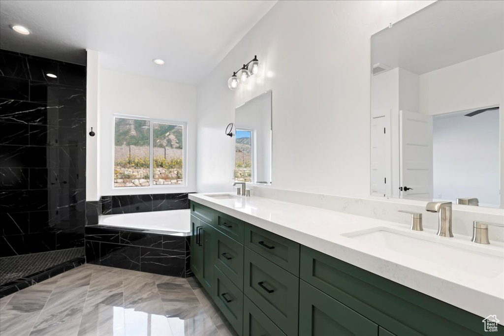 Bathroom featuring vanity and plus walk in shower