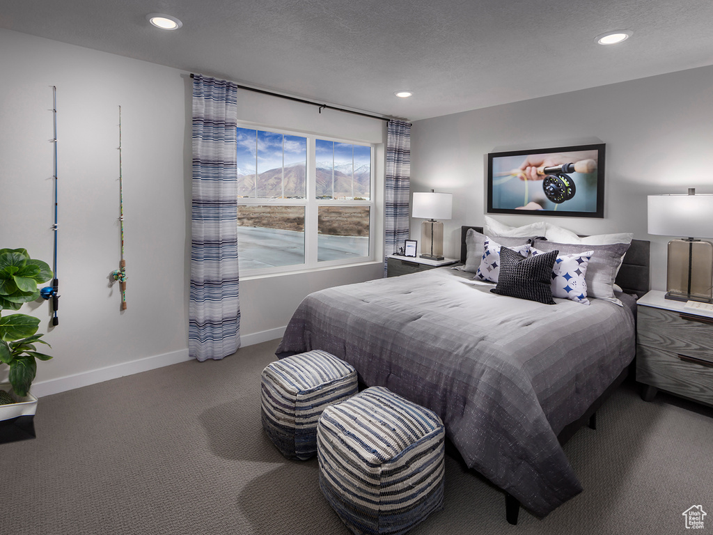 Carpeted bedroom with a textured ceiling