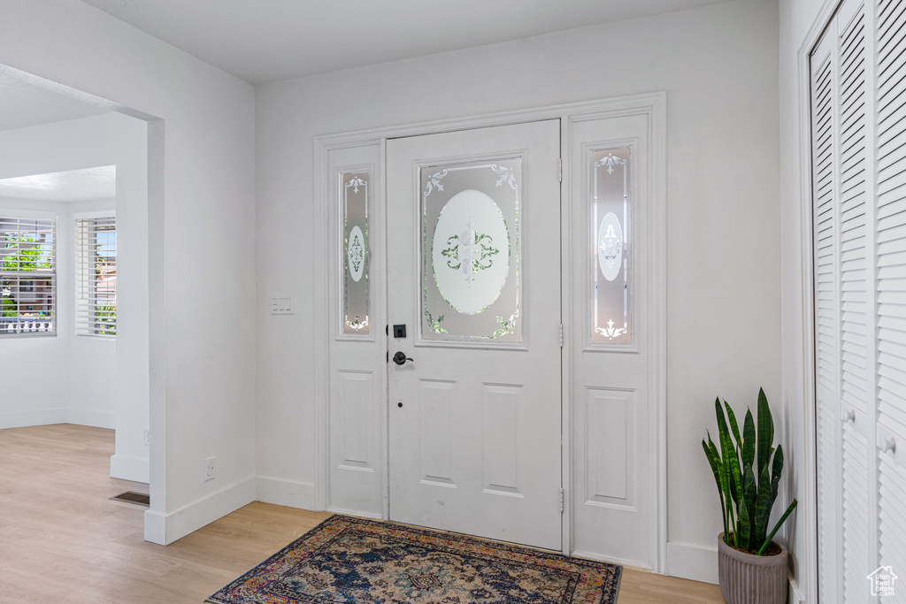 Entrance foyer with light hardwood / wood-style floors