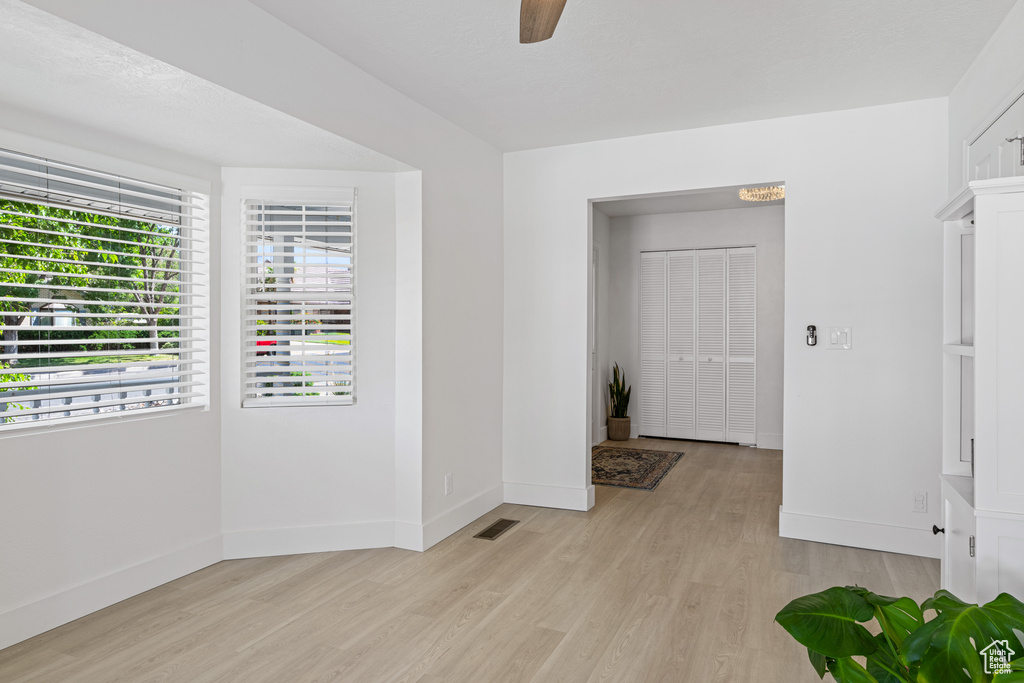 Unfurnished room featuring ceiling fan and light wood-type flooring