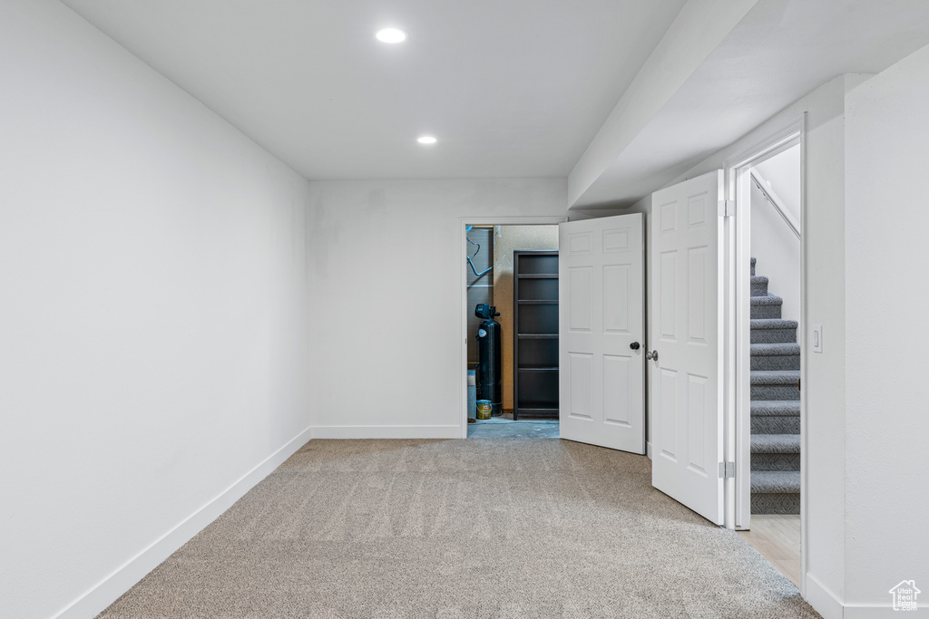 Basement with light colored carpet