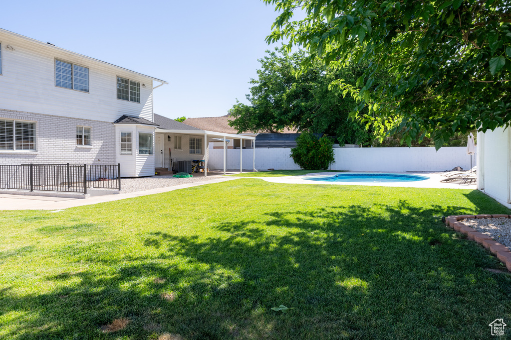 View of yard with a fenced in pool and a patio area