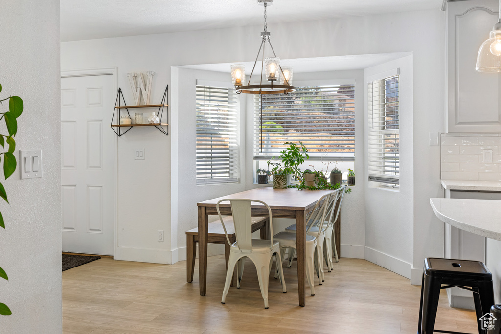 Dining area featuring a chandelier and light hardwood / wood-style floors