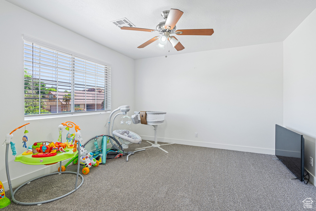 Rec room featuring ceiling fan and carpet floors