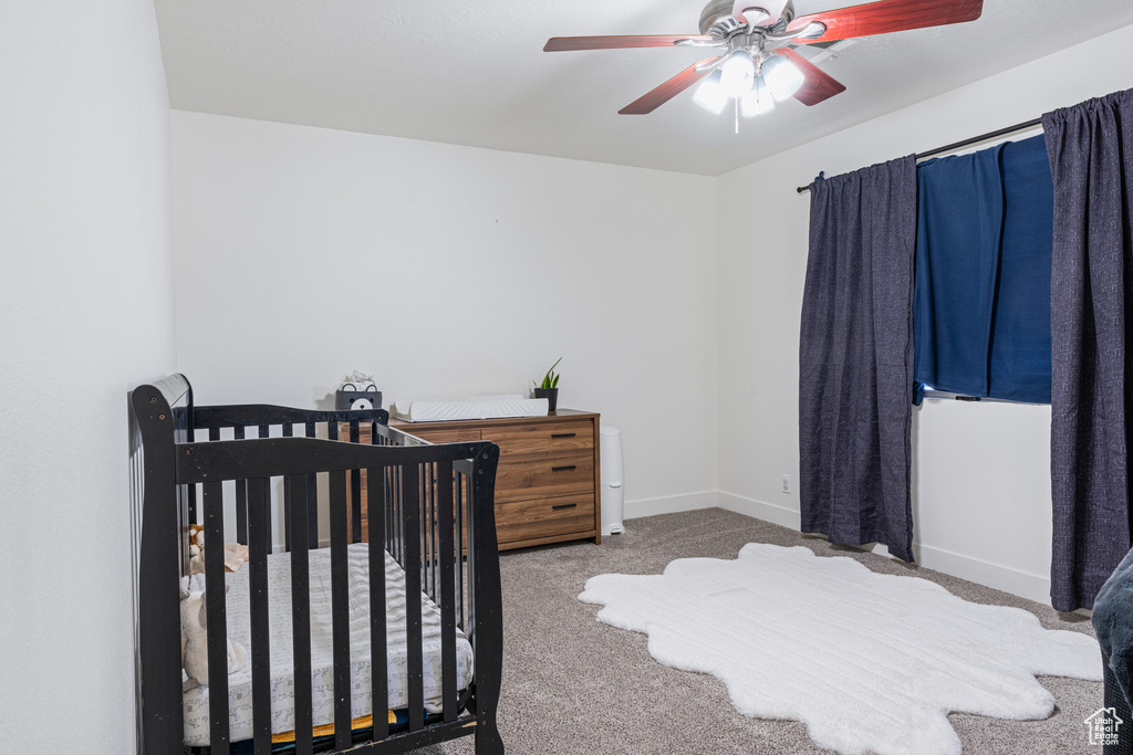 Carpeted bedroom with ceiling fan