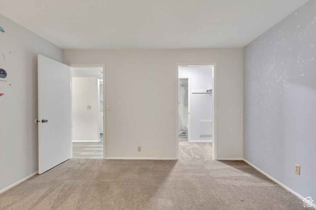 Empty room featuring light carpet