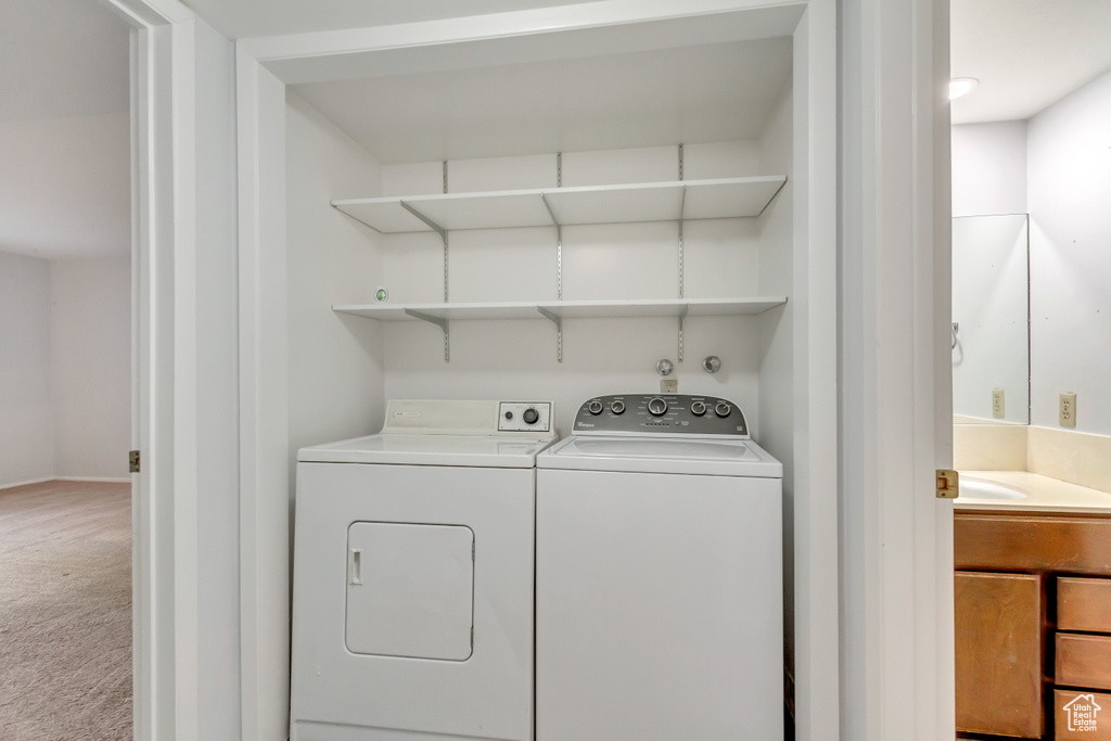 Washroom with carpet and independent washer and dryer