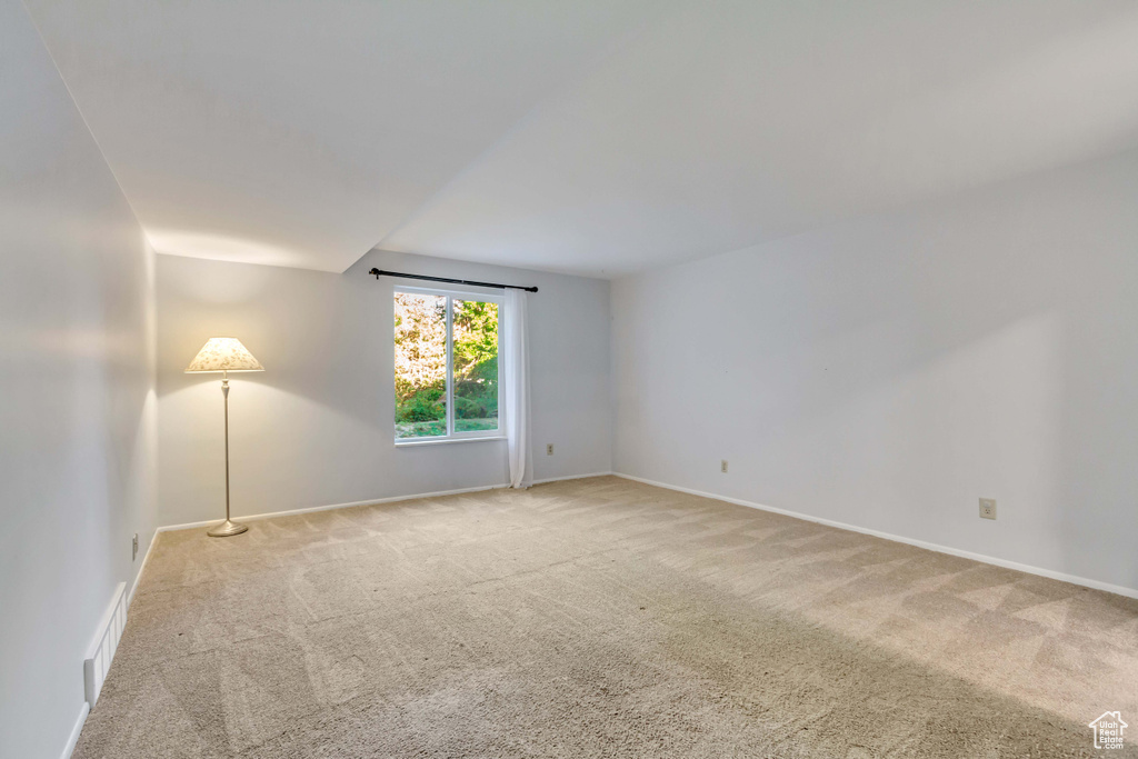 Empty room featuring light carpet