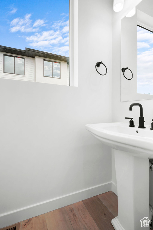 Bathroom with hardwood / wood-style flooring and sink