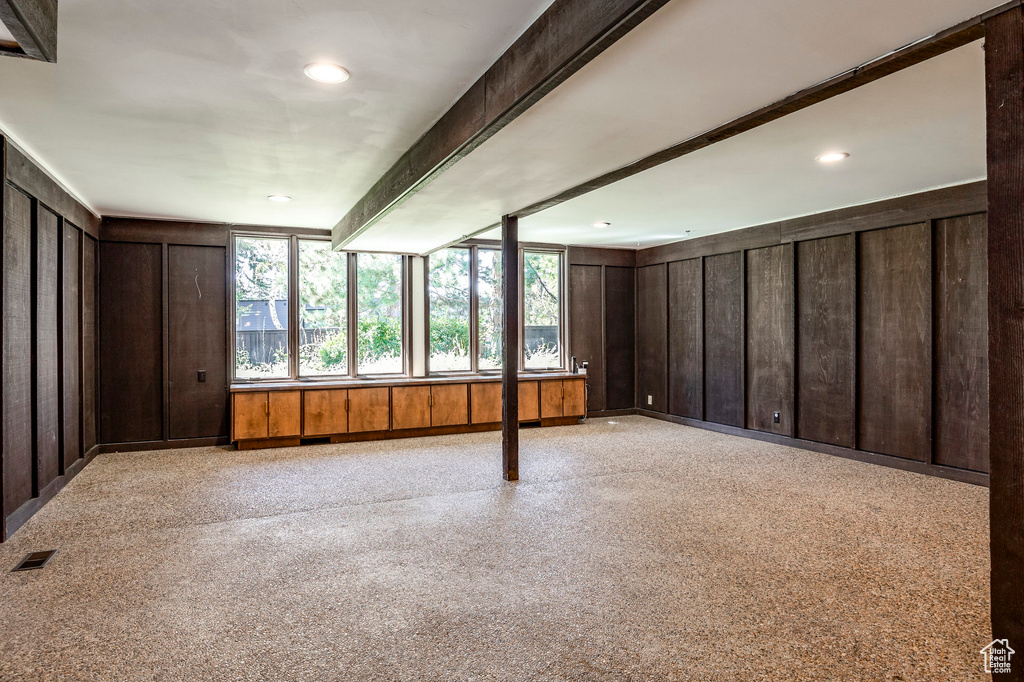 Interior space with beamed ceiling and wooden walls