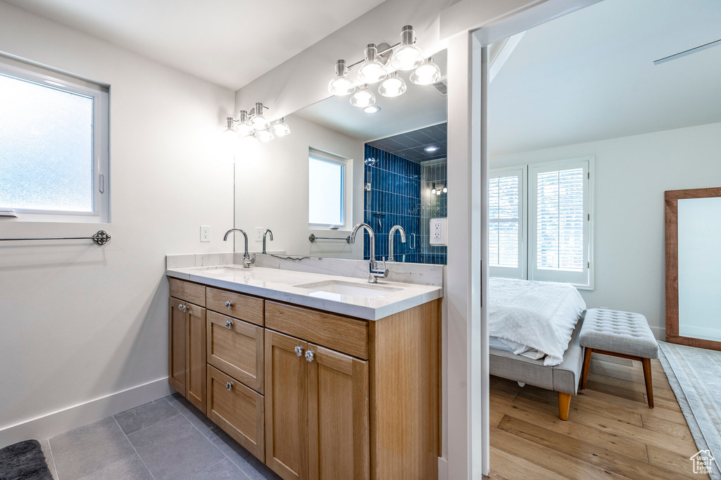 Bathroom with wood-type flooring, vanity, and plenty of natural light