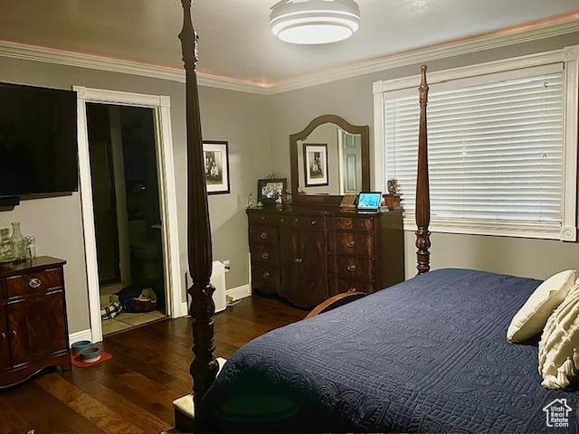 Bedroom with dark hardwood / wood-style floors and ornamental molding