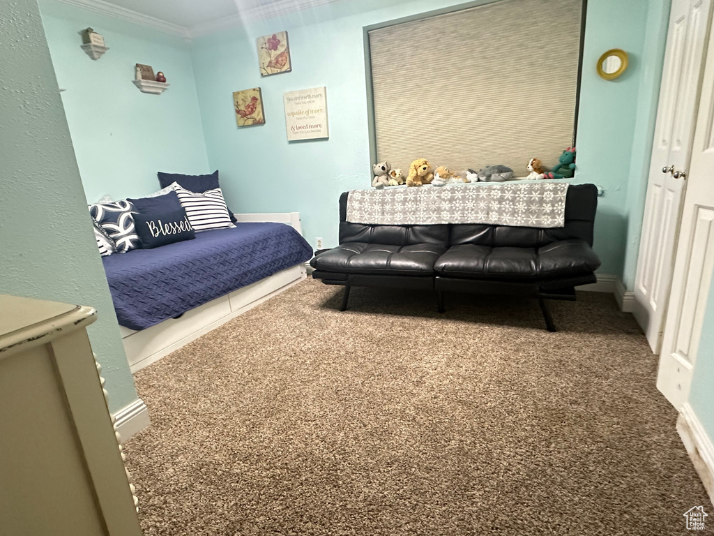 Bedroom featuring carpet floors and ornamental molding