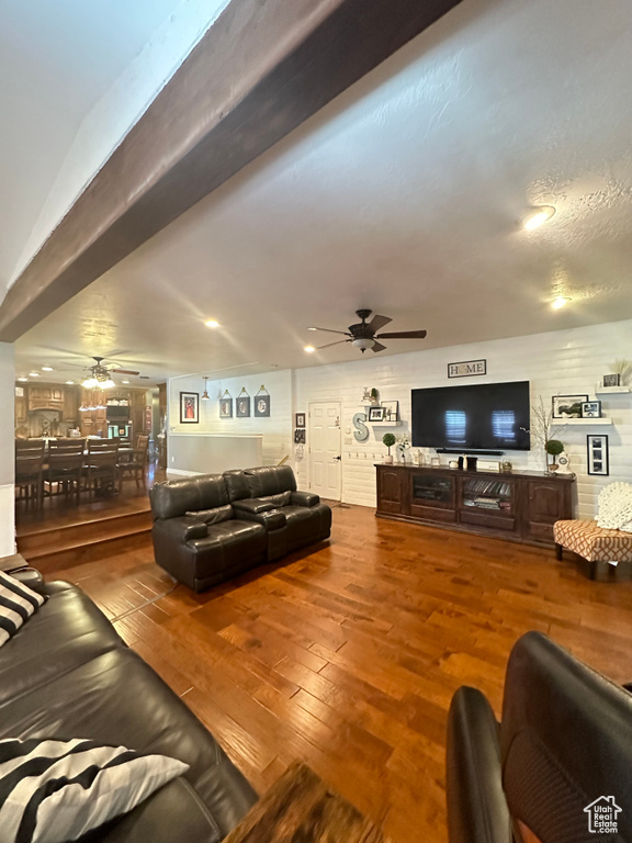 Living room featuring ceiling fan and hardwood / wood-style flooring