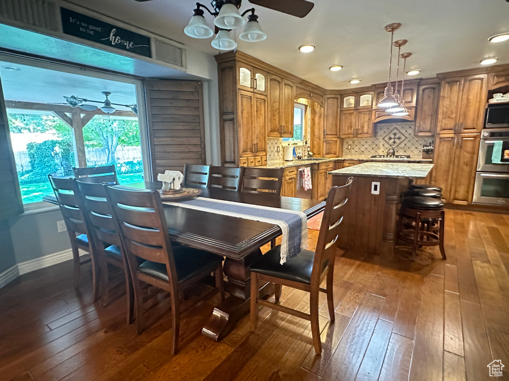 Dining area featuring dark hardwood / wood-style flooring and ceiling fan