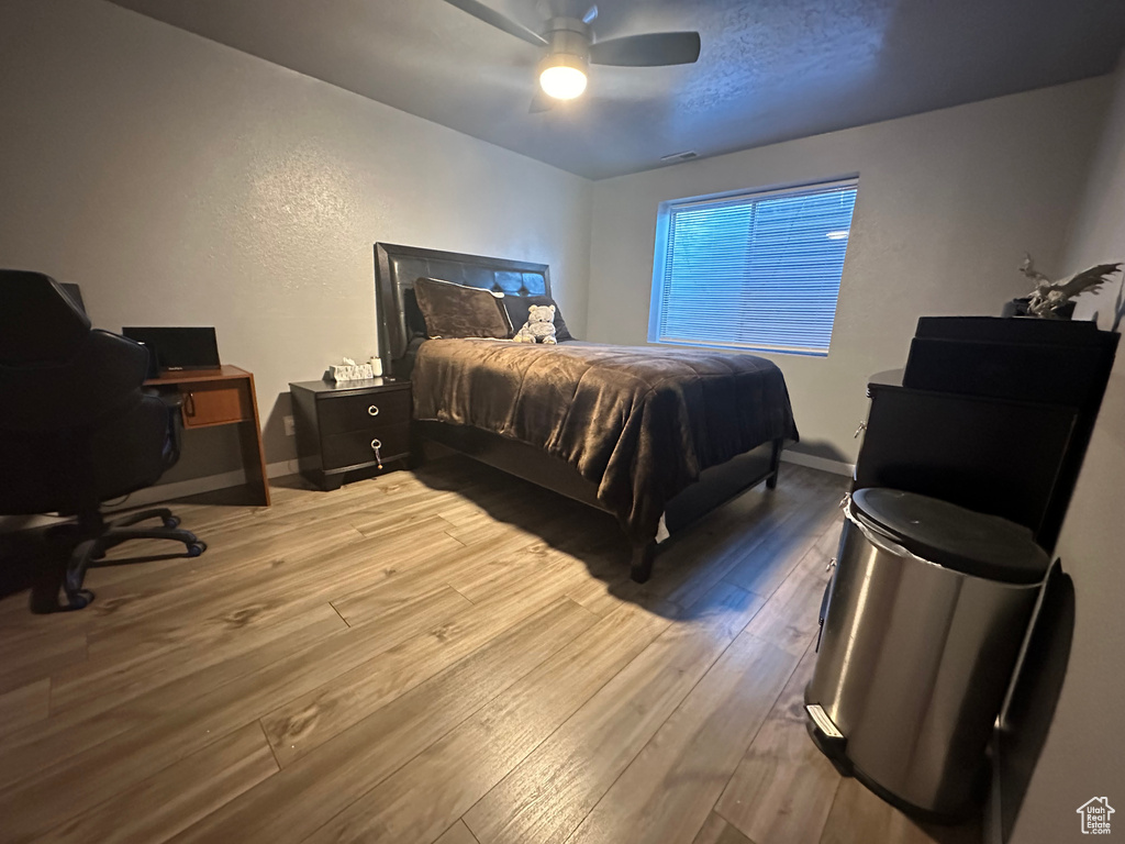 Bedroom featuring ceiling fan and light hardwood / wood-style floors