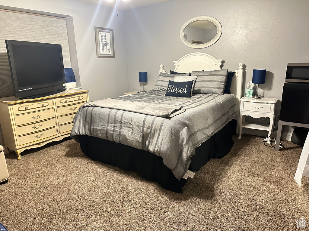 Bedroom featuring dark colored carpet