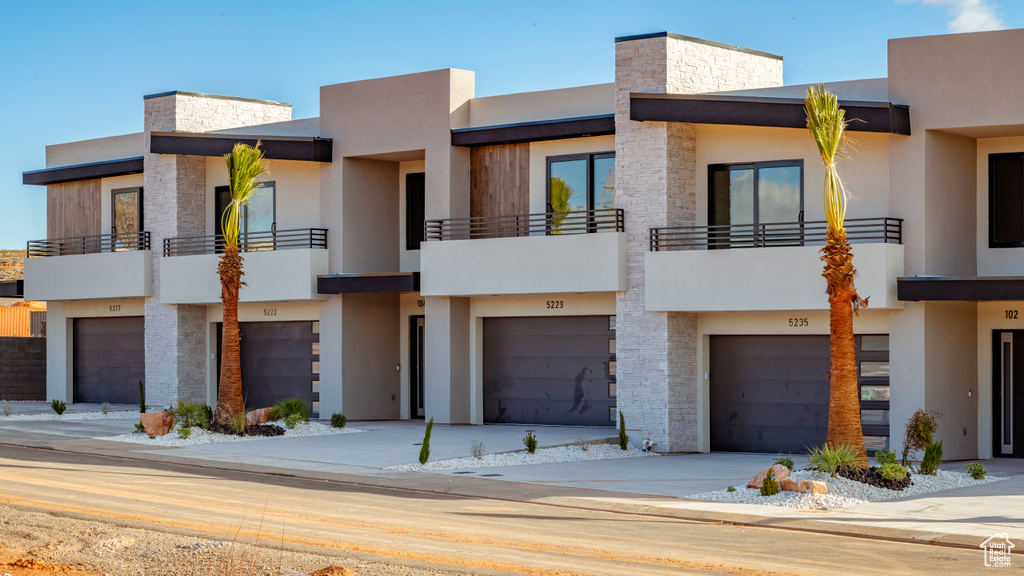 Contemporary house featuring a balcony and a garage