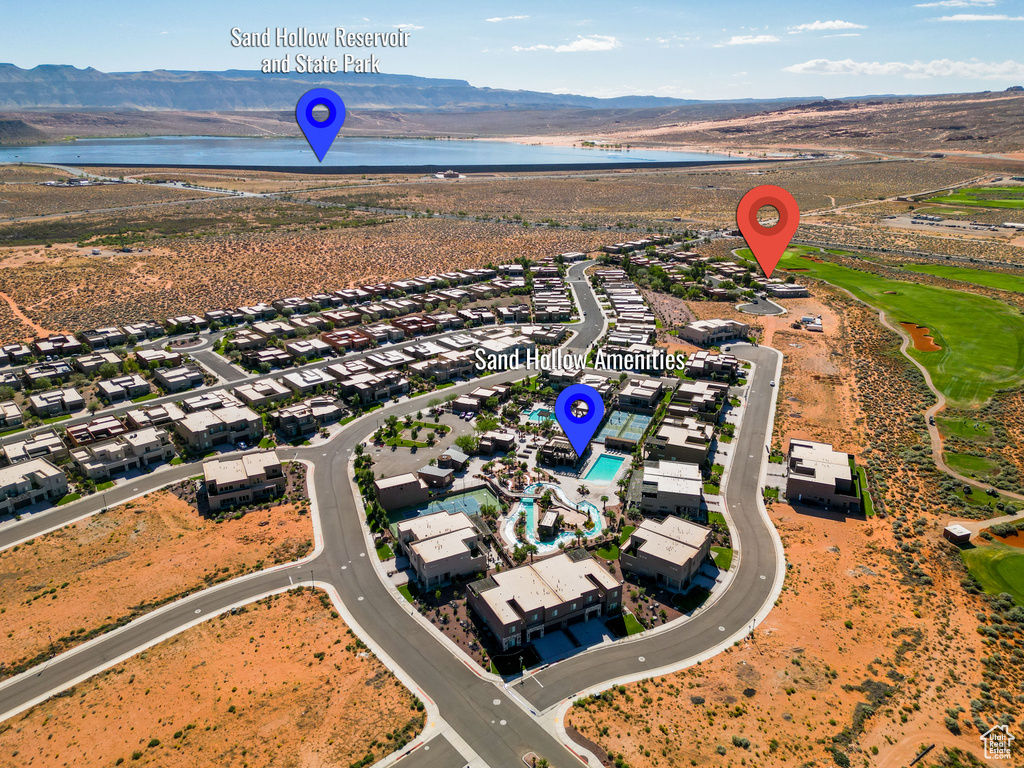 Birds eye view of property featuring a water and mountain view