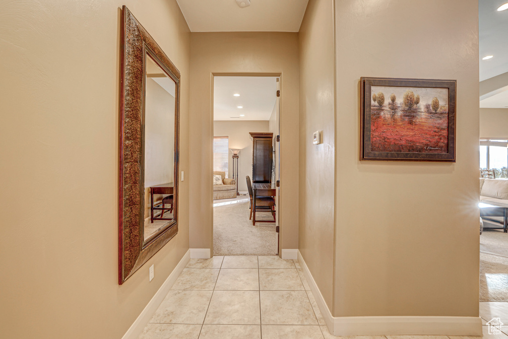 Hall featuring light tile patterned floors