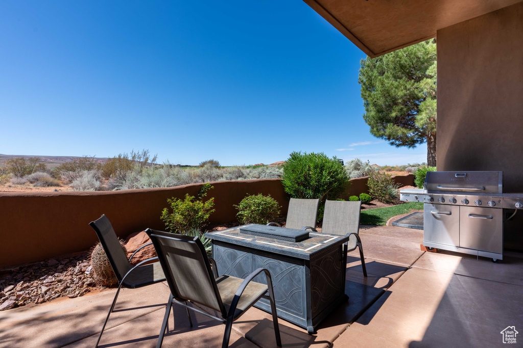 View of patio featuring a grill