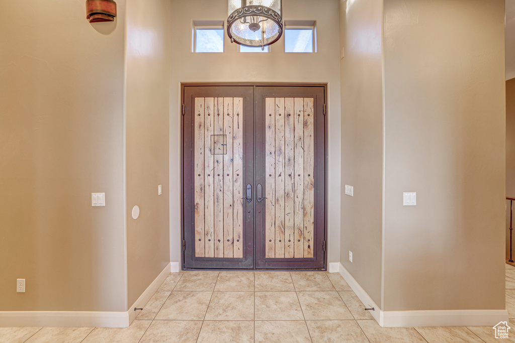 Tiled entrance foyer featuring french doors