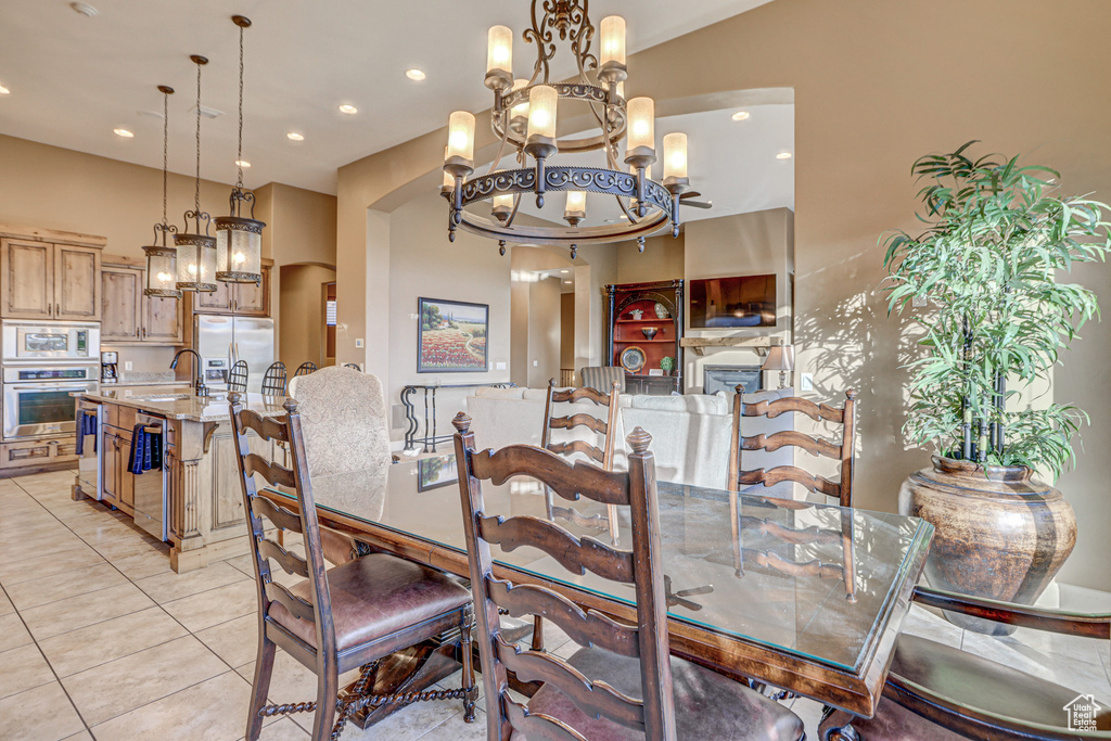 Dining area featuring an inviting chandelier, sink, and light tile patterned floors