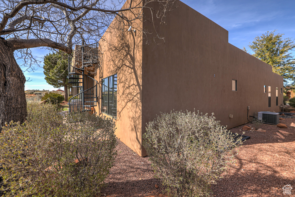 View of side of property with central AC unit