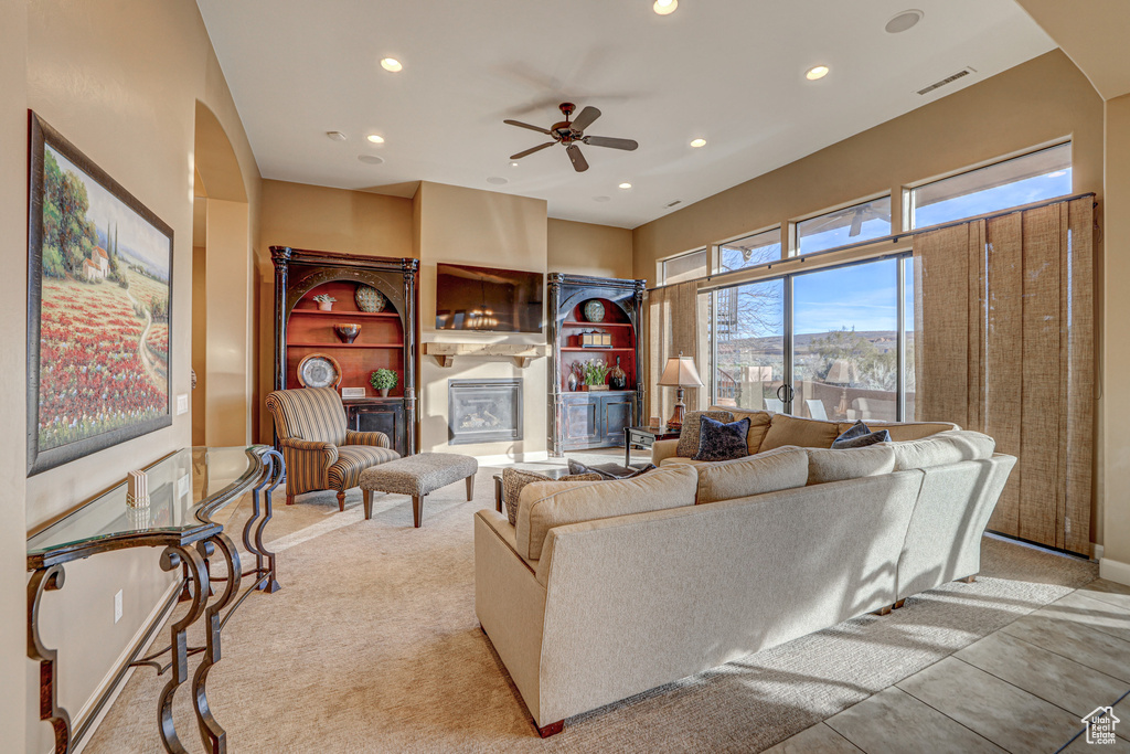 Living room with light carpet and ceiling fan