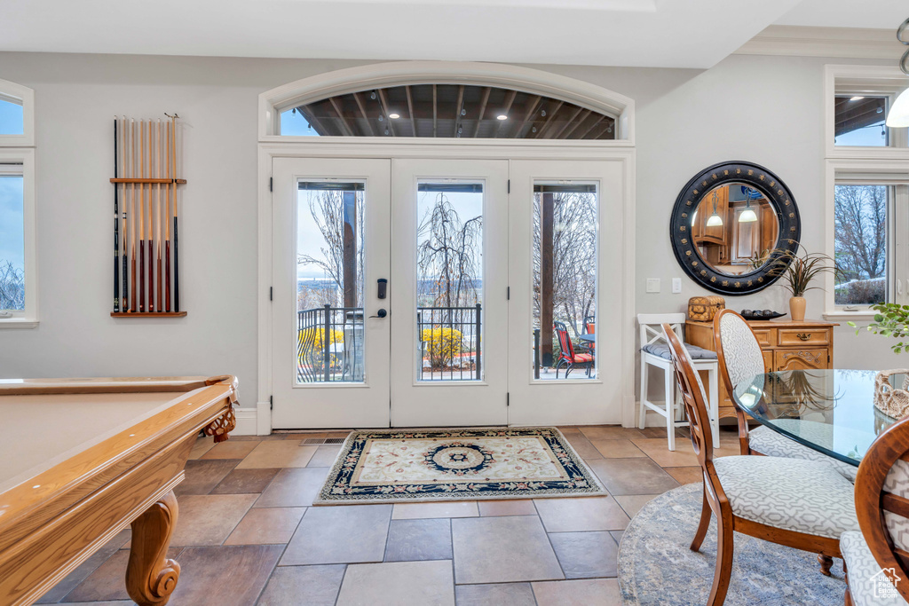 Entryway featuring a healthy amount of sunlight, billiards, and french doors