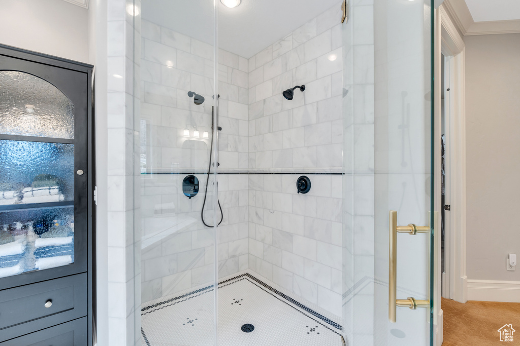 Bathroom with walk in shower and crown molding