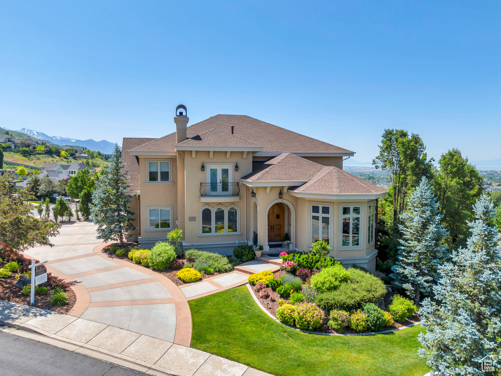 Mediterranean / spanish home featuring a mountain view and a front lawn