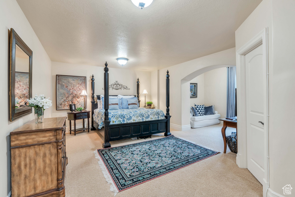 Bedroom with a textured ceiling and carpet