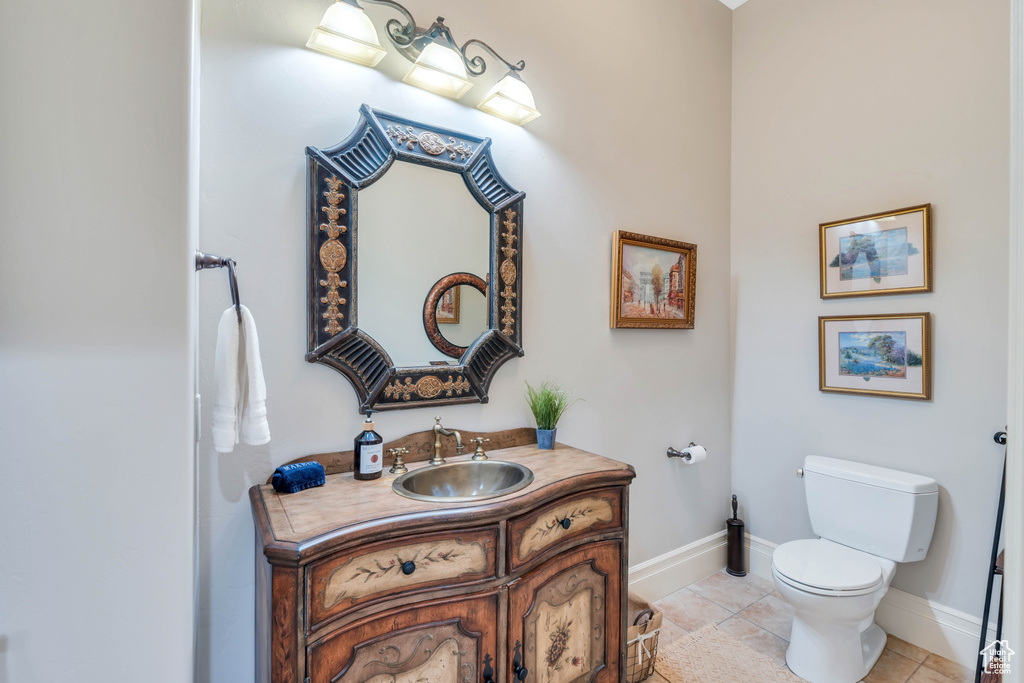 Bathroom featuring tile patterned flooring, vanity, and toilet