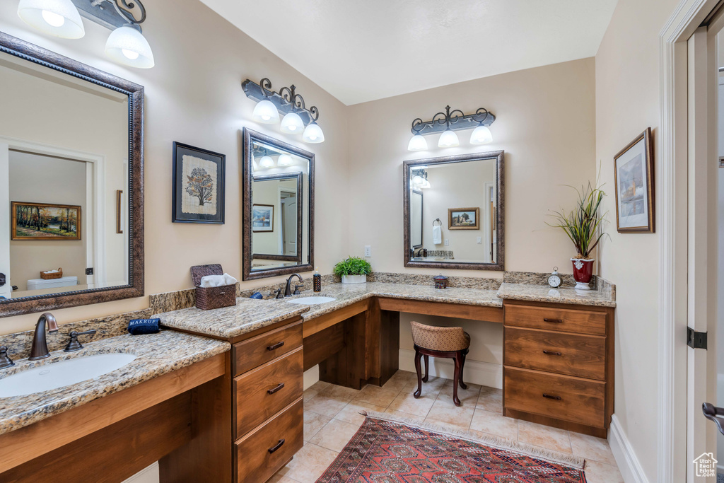 Bathroom with tile patterned floors and vanity