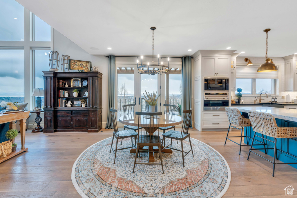 Dining space featuring a chandelier, light hardwood / wood-style floors, and sink