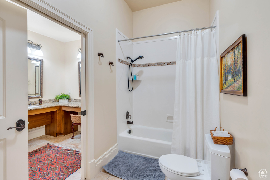 Full bathroom with shower / tub combo with curtain, vanity, toilet, and tile patterned floors