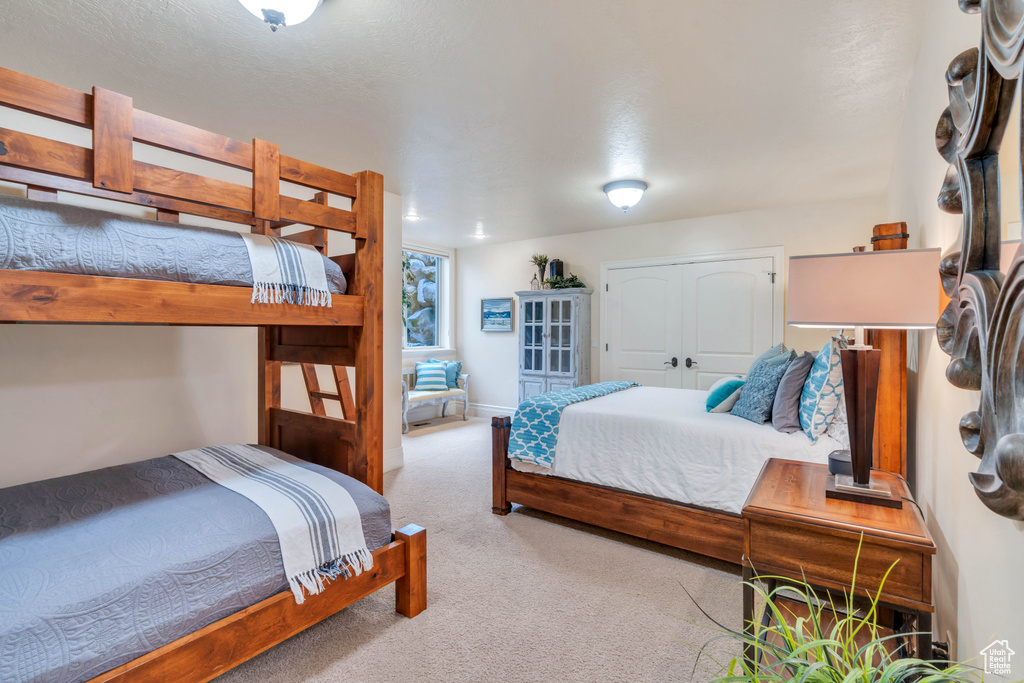 Carpeted bedroom featuring a closet