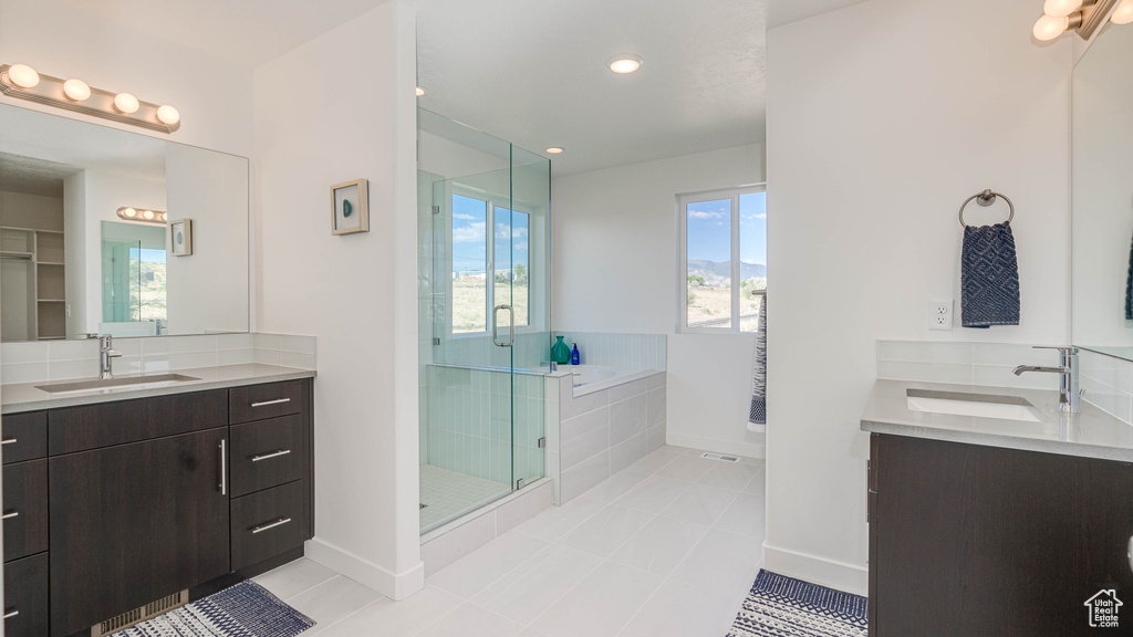 Bathroom featuring independent shower and bath, tile patterned flooring, and vanity