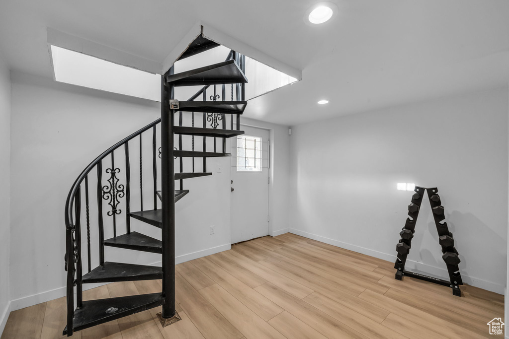 Stairs featuring wood-type flooring