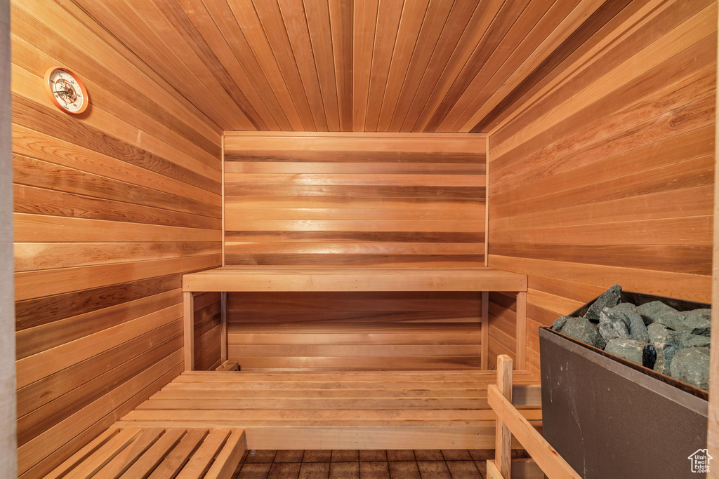 View of sauna with wooden walls, hardwood / wood-style flooring, and wooden ceiling